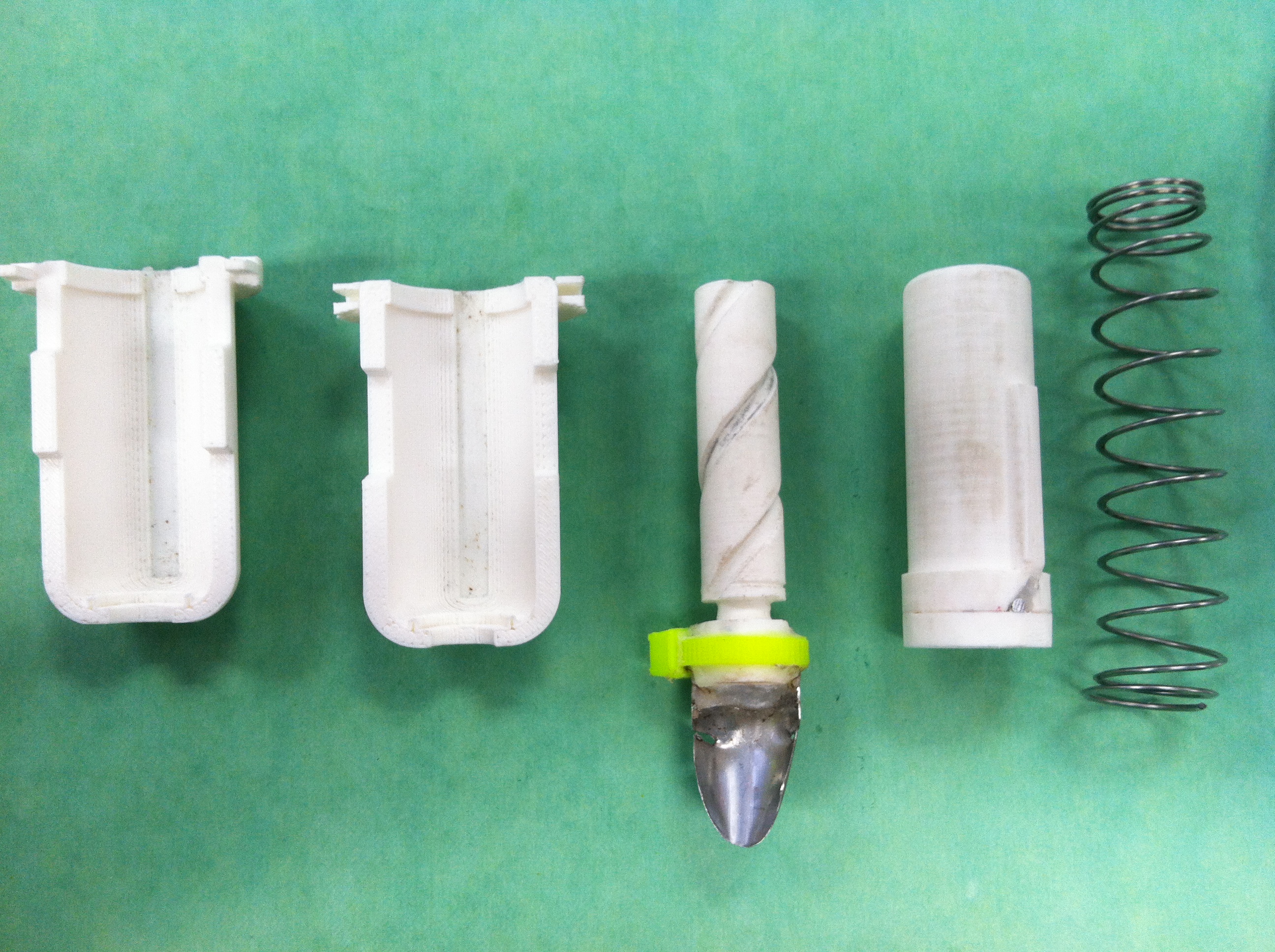 Disassembled strawberry huller prototype components