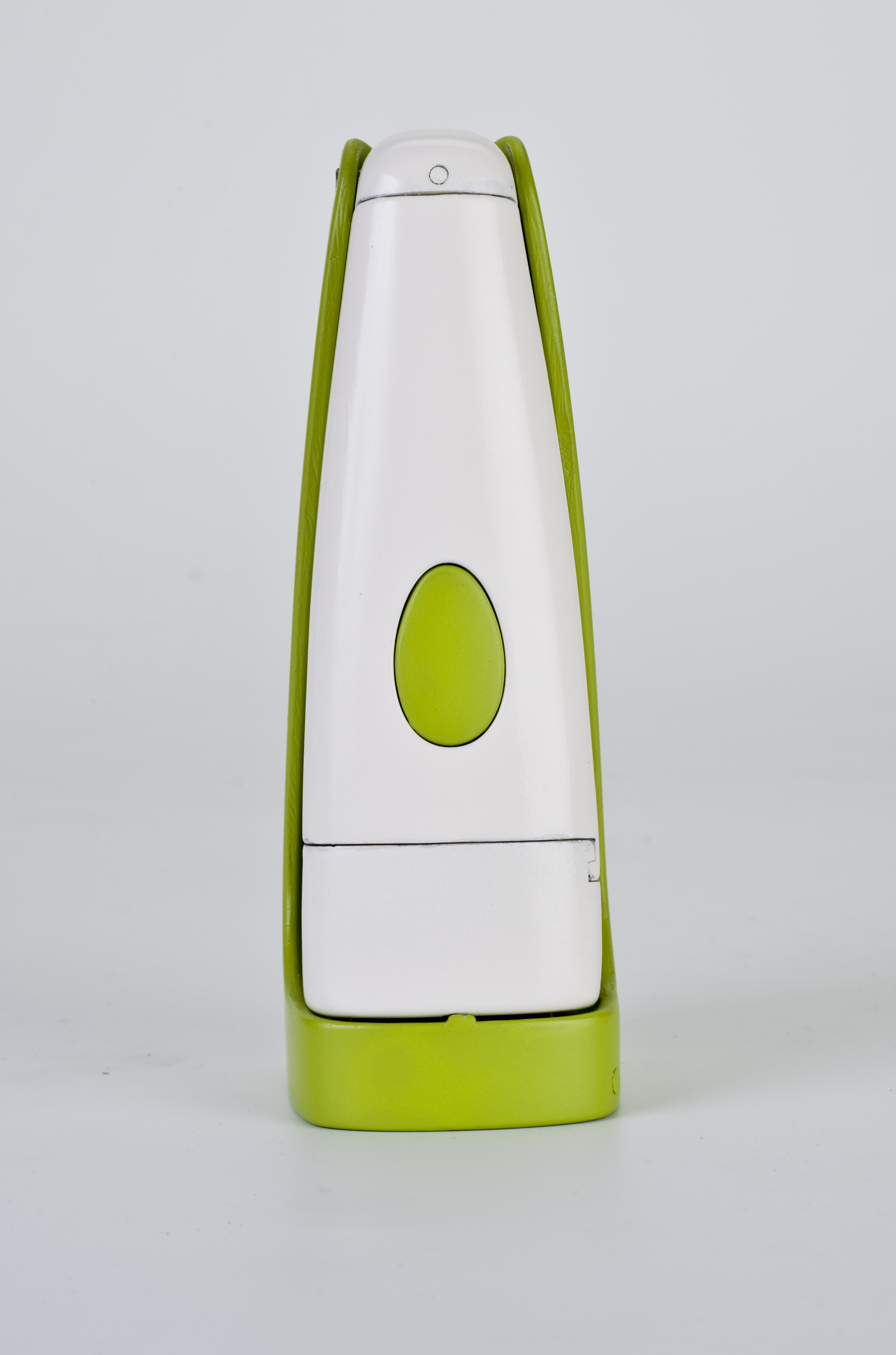 Front view of a green and white garlic mincer prototype