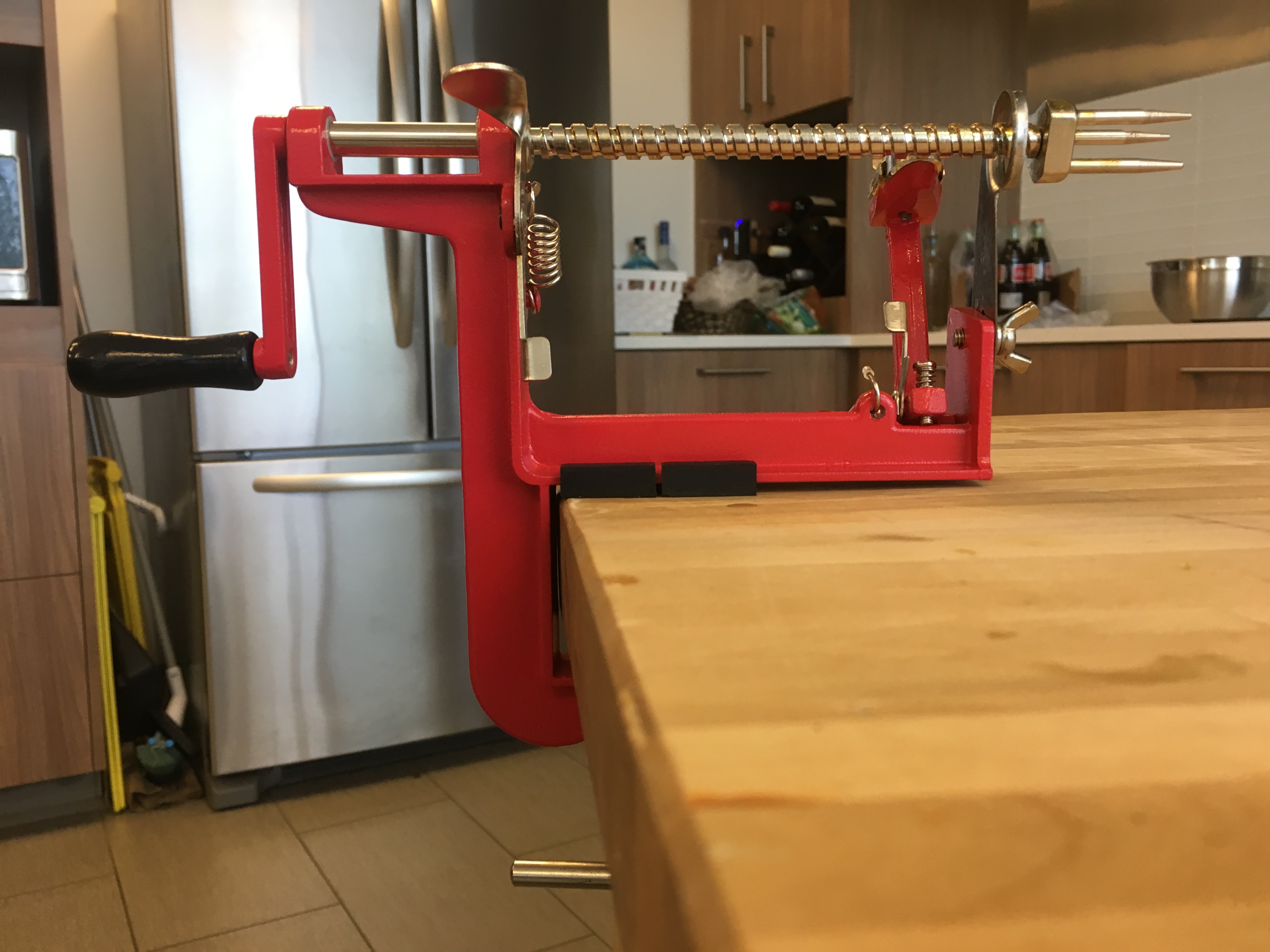 Traditional cast-iron apple parer clamped to a countertop