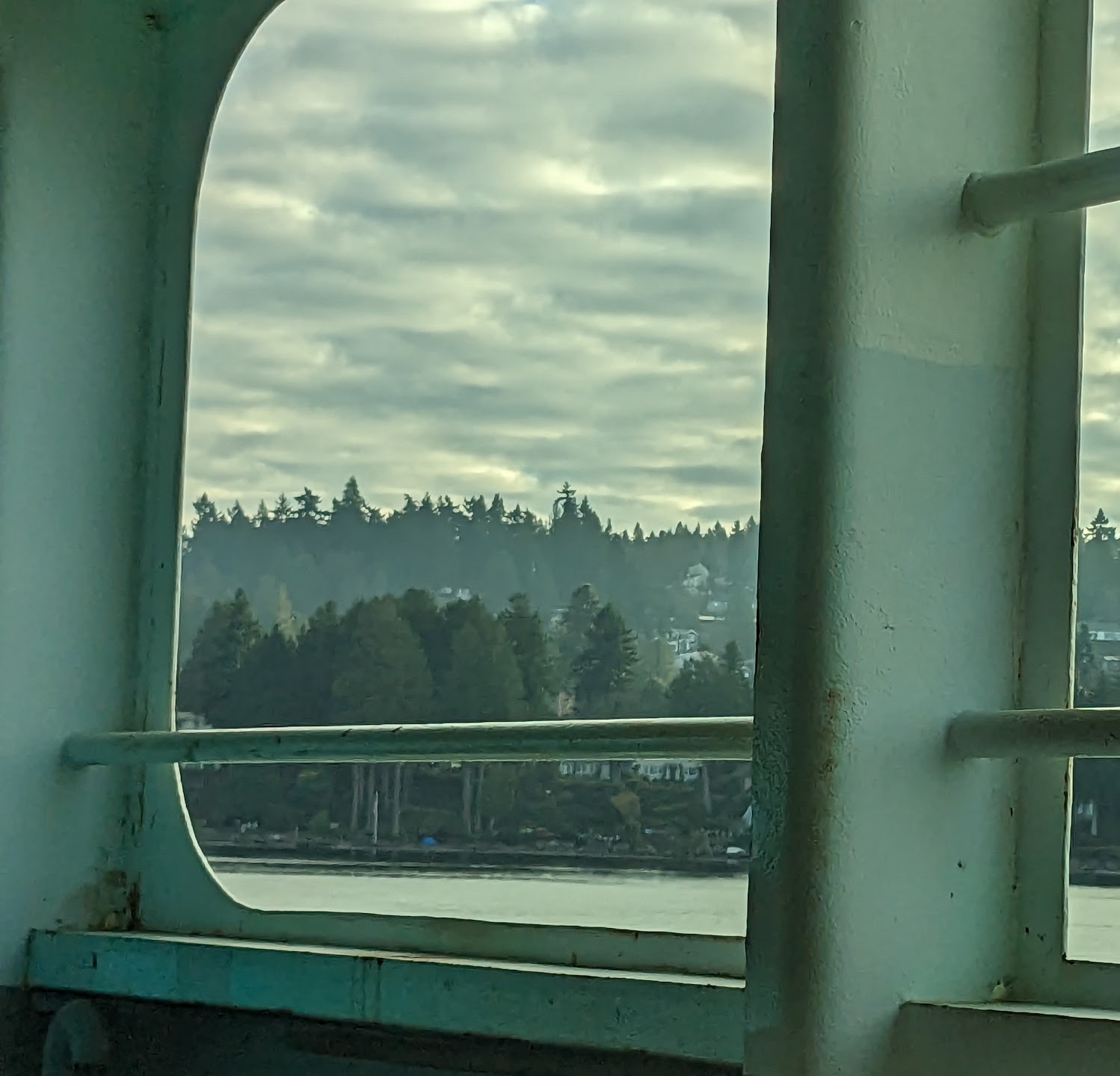 Landscape seen through a green-painted window